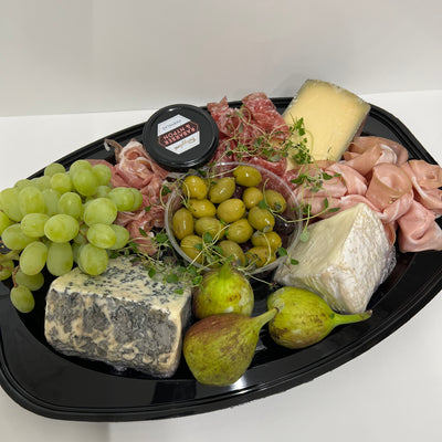En smakfull tallrik med en harmonisk kombination av ostar, oliver, fikon och frukter.